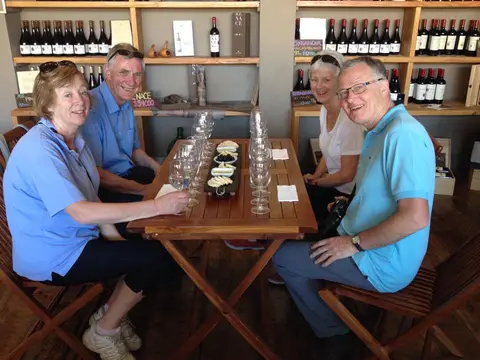 Four guests seated around a tasting table with a cheese board in the Bodegas RE tasting room